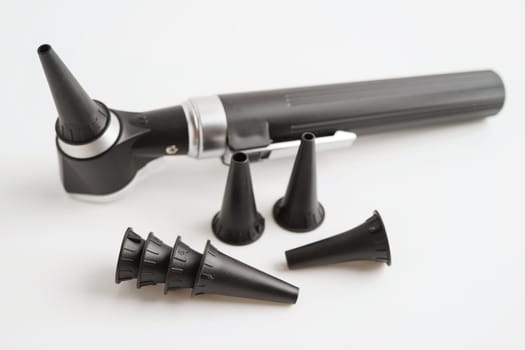 Otoscope isolated on white background for otolaryngologist or ENT physician doctor examining senior patient ear, hearing loss problem.