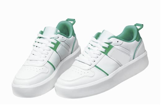 White sneaker. Close-up of a pair white elegant stylish female leather high-heeled sport shoes isolated. Clipping path. Womens shoe fashion. Modern design footwear for workout.