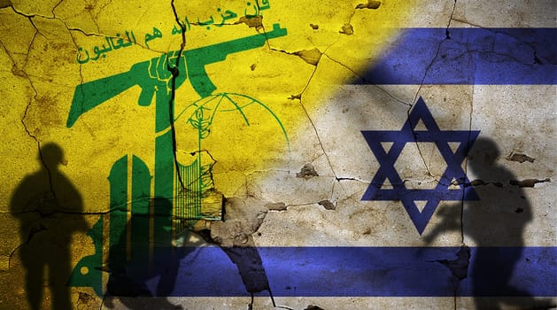 Israel vs Hezbollah flag on cracked wall. Conflict between Hezbollah and Israel concept. Political tension between Hezbollah and Israel