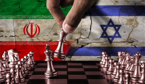 Israel vs Iran flag concept on chessboard. Political tension between Iran and Israel. Conflict between Israel and Iran on pieces of chessboard