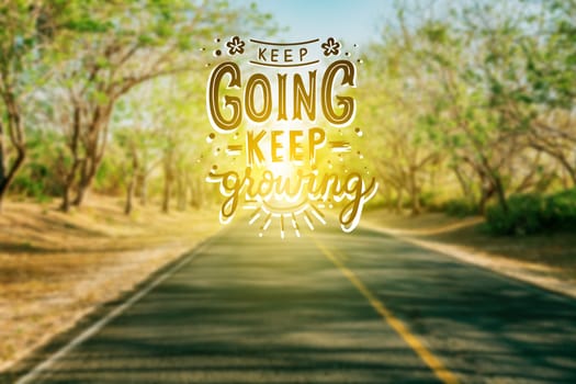 Urban road with motivational message , KEEP GOING, KEEP GROWING. Asphalt road with motivational phrase, KEEP GOING, KEEP GROWING