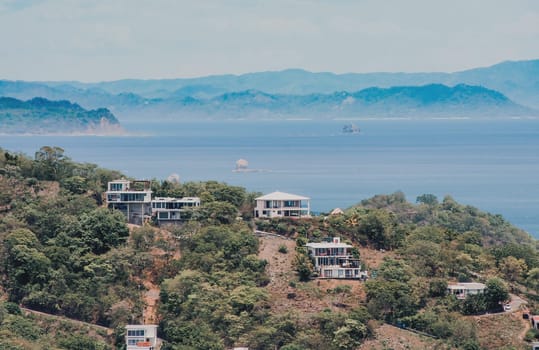View of houses on top of a hill overlooking the beach, San Juan del Sur. Houses on top of a hill overlooking the ocean
