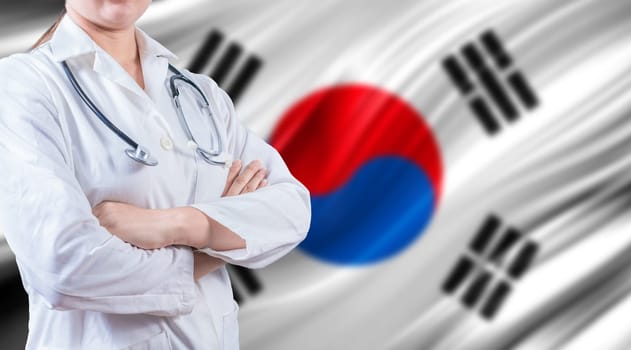 Doctor with stethoscope on South Korean flag. Health and care on South Korean flag. Doctor with crossed arms on South Korean flag