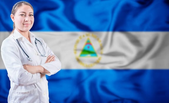 Doctor with crossed arms on Nicaragua flag background. Doctor with stethoscope on Nicaraguan flag. Nicaragua Health and Care concept