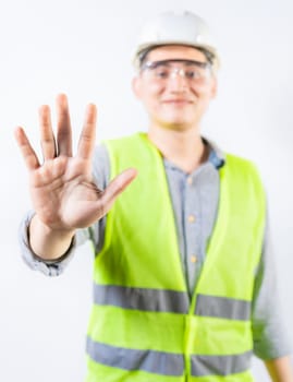 Young engineer counting number five isolated. Smiling engineer showing number five with hand isolated