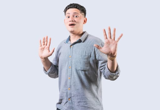 Scared man with raised hands isolated. Young man with scared face with raised hands. Scared and horrified guy with raised palms