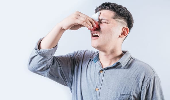 Man suffering from sinusitis isolated. People suffering with irritated nose isolated. Concept of nasal congestion
