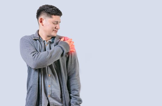 Person in pain holding his shoulder isolated. Youg man suffering with arms pain isolated