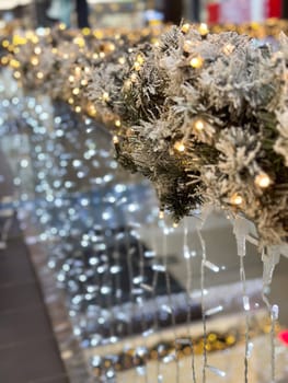 Close-up shot captures a beautifully frosted garland adorned with twinkling lights in Christmas festive indoor setting. Warm glow creates a magical atmosphere, perfect for the holiday season.