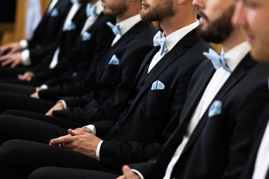 Guests sit on benches during a wedding in the Catholic Church.