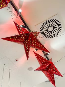 Cozy Christmas holiday scene is decorated with vibrant red ornaments and lush greenery, evoking a festive and cheerful atmosphere. warm lights softly illuminate the space, creating a magical winter ambiance.