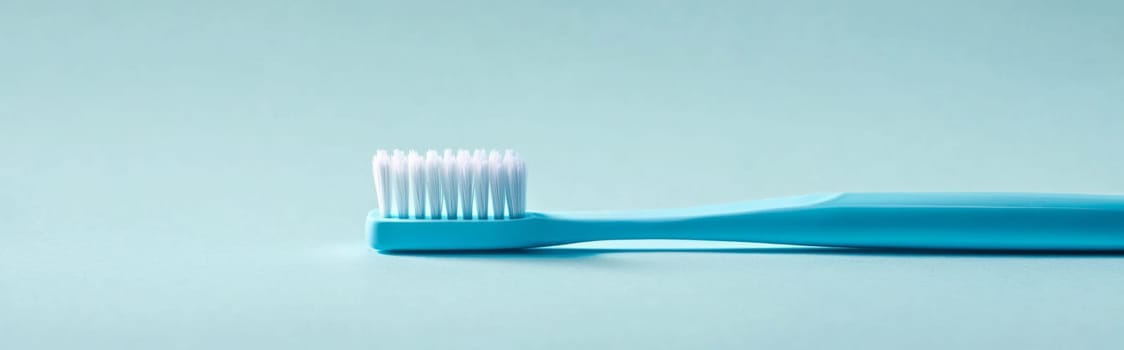 Toothbrush with blue handle on light blue background, concept of dental hygiene, AI Generated