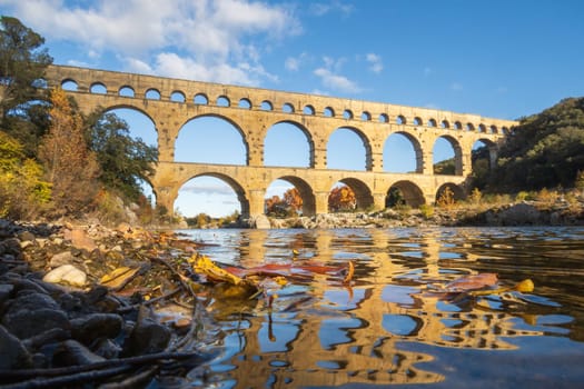 The Pont du Gard, ancient roman aqueduct bridge, photographed from the river in Provence, southern France