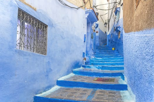 Staircase in a narrow blue street in the city of Chefchaouen. Morocco.