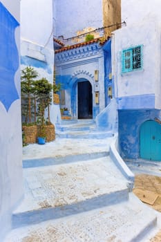 Typical alley in the blue city Chefchaouen.  Morocco. Vertically.