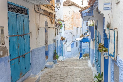 Traditional alley in the historic blue town Chefchaouen in Morocco. Horizontally.
