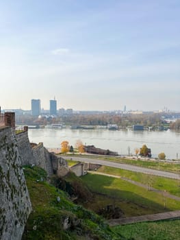 Looking across the Sava river in Belgrade, river boats in the foreground and a variety of office blocks in the distance. Belgrade in autumn season.