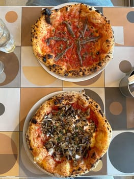 Delicious pizza served on a colorful table. Italian cuisine and diverse flavors in a casual dining experience.