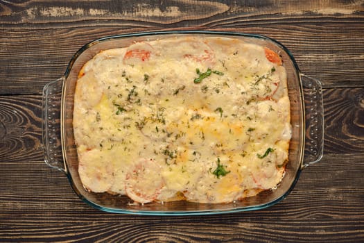 A hearty casserole is freshly baked, featuring layers of colorful vegetables and melted cheese