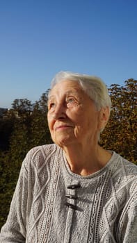 Portrait of beautiful senior woman posing in autumn park