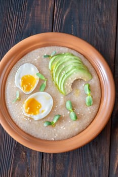 Amaranth Porridge bowl with eggs and avocado
