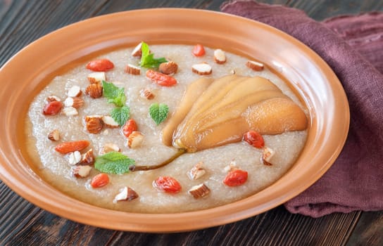 Amaranth Porridge with poached pear, almond and goji