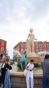 Nice, France - September 22, 2024: People going at Place Massena - people, transport and architecture in cloudy weather, city views of Nice, French Riviera, France