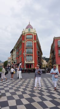 Nice, France - September 22, 2024: People going at Place Massena - people, transport and architecture in cloudy weather, city views of Nice, French Riviera, France