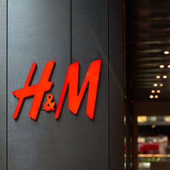 Company logo of the textile discounter H&M in the city center of Leipzig in Germany