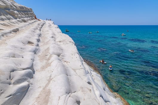 Sicily, Italy: August 9, 2024: Some people at the Beach of Scala dei Turchi (Stair of the Turks) in Sicily, Italy