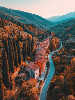 A charming village with terracotta roofs winds through vibrant autumn foliage, framed by cypress trees and a winding road against misty mountains.