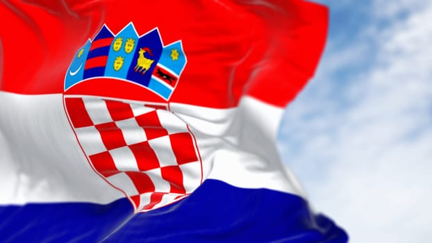 Close-up of Croatia national flag waving in the wind on a clear day. Red, white and blue horizontal stripes with coat of arms in center. 3d illustration render. Fluttering fabric. Selective focus