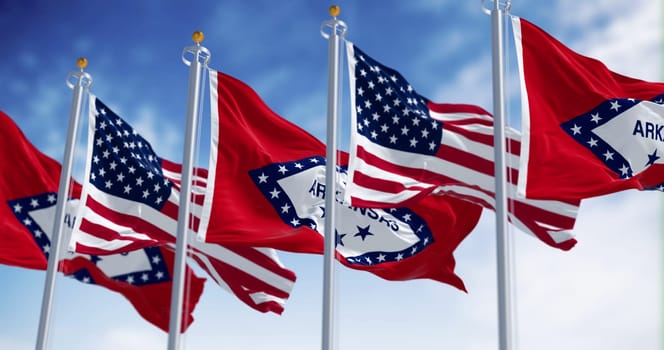 Arkansas state flags waving with the American flags on a clear day. 3d illustration render. Selective focus. Rippling fabric