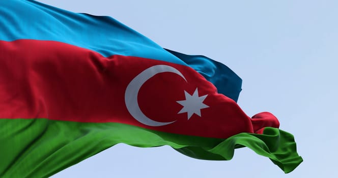 Close-up of national flag of Azerbaijan waving in the wind on a clear day. Horizontal tricolour of blue, red, green with a white crescent and star. 3D illustration render. Selective focus