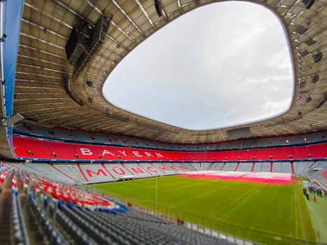 Munich, DE, Dec. 22 2022  The empty interior of Allianz Arena, home stadium of FC Bayern Munich, showing the iconic red seating and the field. The arena is prepared for an upcoming event