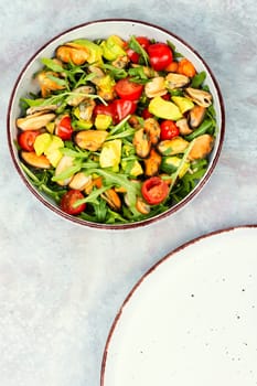 Seafood salad with vegetables and mussels.