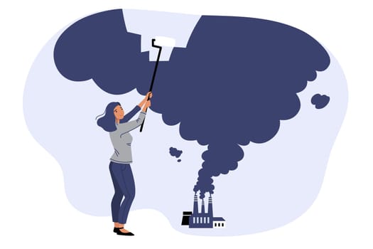 Woman ecologist fights harmful emissions from industrial factory using roller to remove smoke. Problem of harmful emissions from enterprises negatively affecting environment and causing climate change