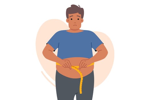 Fat man suffering from obesity measures waist and sadly looks at screen, looking for help. Problem of obesity upsets guy who does not follow diet due to lack of willpower and motivation