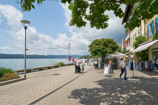 Ueberlingen, Germany – August 02, 2024: Lake promenade, Seepromenade with some stores and tourists in Uberlingen on Lake Constance, Bodensee