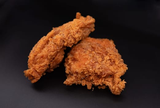 Fried chicken on black background