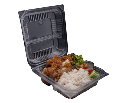 Fried  Pork Rice is put in a clear plastic box.
