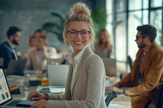A diverse group of businesspeople discuss together in a modern workspace.
