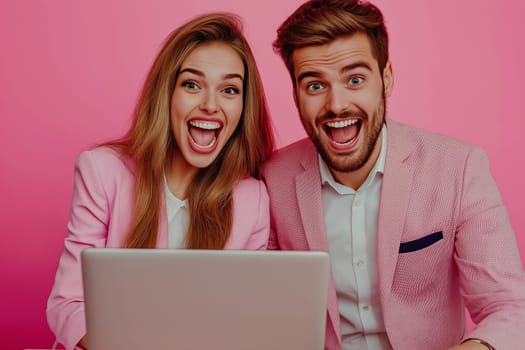 Happy business couple looking at a laptop use wireless netbook develop project