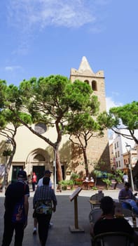 Lloret de mar, Spain - September 30, 2024: People going near Parish Church of Sant Roma. Lloret de Mar, Spain, Costa Brava, province Girona at Catalonia.