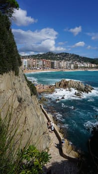 Lloret de mar, Spain - September 30, 2024: People resting at the beach of Lloret De Mar. The beach in Costa Brava of Catalonia at sunny day