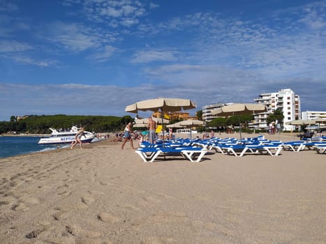 Lloret de mar, Spain - September 30, 2024: People resting at Fenals beach in Lloret de Mar in the Costa Brava, Catalonia, Spain