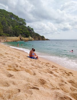 Lloret de mar, Spain - September 30, 2024: People resting at Fenals beach in Lloret de Mar in the Costa Brava, Catalonia, Spain