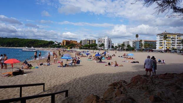 Lloret de mar, Spain - September 30, 2024: People resting at Fenals beach in Lloret de Mar in the Costa Brava, Catalonia, Spain