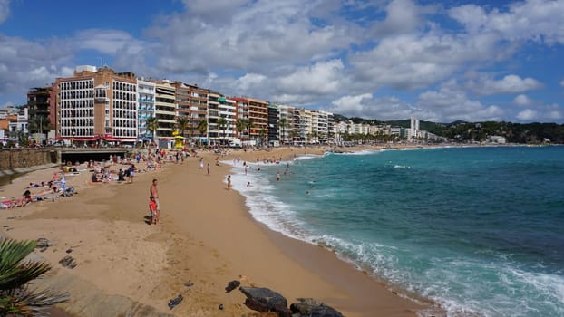 Lloret de mar, Spain - September 30, 2024: People resting at the beach of Lloret De Mar. The beach in Costa Brava of Catalonia at sunny day