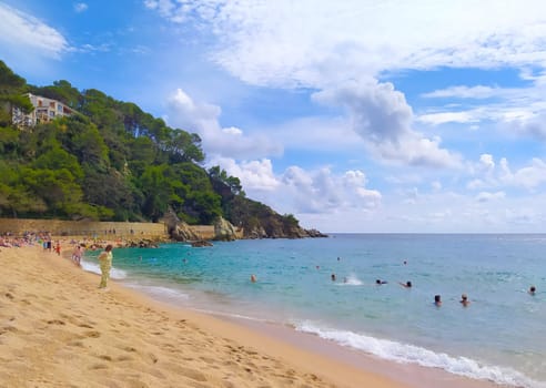 Lloret de mar, Spain - September 30, 2024: People resting at Fenals beach in Lloret de Mar in the Costa Brava, Catalonia, Spain